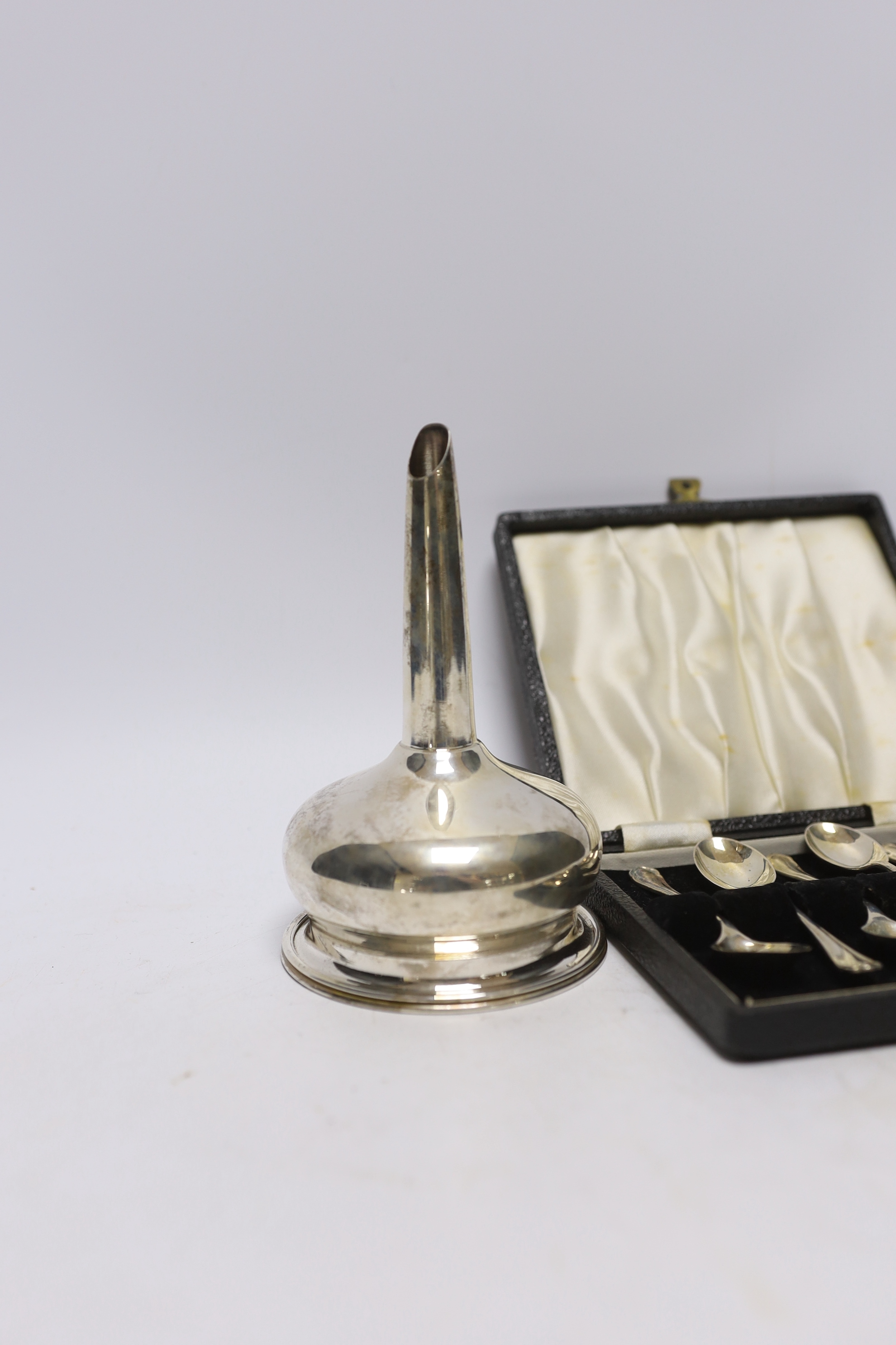 A modern silver wine funnel, Broadway & Co, London, 2003, 13.1cm and a cased set of six earlier silver coffee spoons.